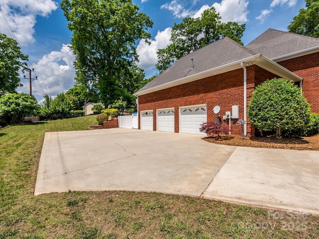 1209 S S St, Gastonia, NC 28052 - view of side of property featuring brick siding, driveway, a lawn, and an attached garage