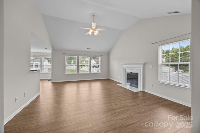423 Courtland Ct, Kannapolis, NC 28081 - unfurnished living room featuring vaulted ceiling, a fireplace, a ceiling fan, wood finished floors, and baseboards