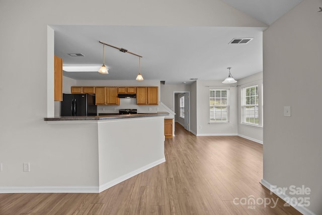 423 Courtland Ct, Kannapolis, NC 28081 - kitchen featuring freestanding refrigerator, brown cabinetry, light wood finished floors, and hanging light fixtures