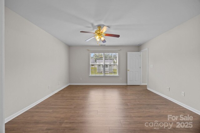423 Courtland Ct, Kannapolis, NC 28081 - unfurnished room featuring a ceiling fan, dark wood-style flooring, and baseboards