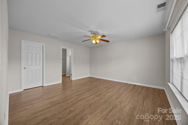 423 Courtland Ct, Kannapolis, NC 28081 - unfurnished bedroom featuring wood finished floors, baseboards, a ceiling fan, and a spacious closet