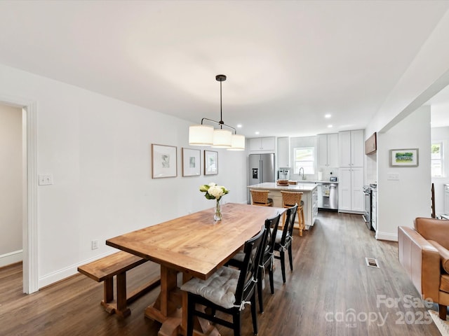 1638 Wensley Dr, Charlotte, NC 28210 - dining room featuring dark wood-type flooring, baseboards, recessed lighting, and plenty of natural light