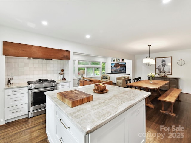 1638 Wensley Dr, Charlotte, NC 28210 - kitchen with stainless steel gas range oven, dark wood finished floors, white cabinetry, backsplash, and a kitchen island