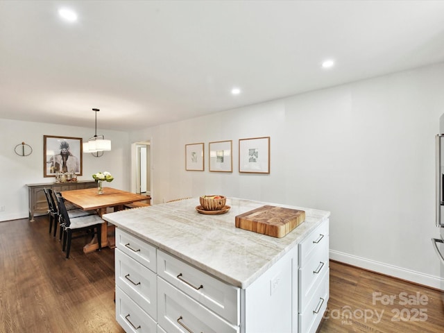 1638 Wensley Dr, Charlotte, NC 28210 - kitchen with dark wood finished floors, a kitchen island, white cabinetry, hanging light fixtures, and recessed lighting
