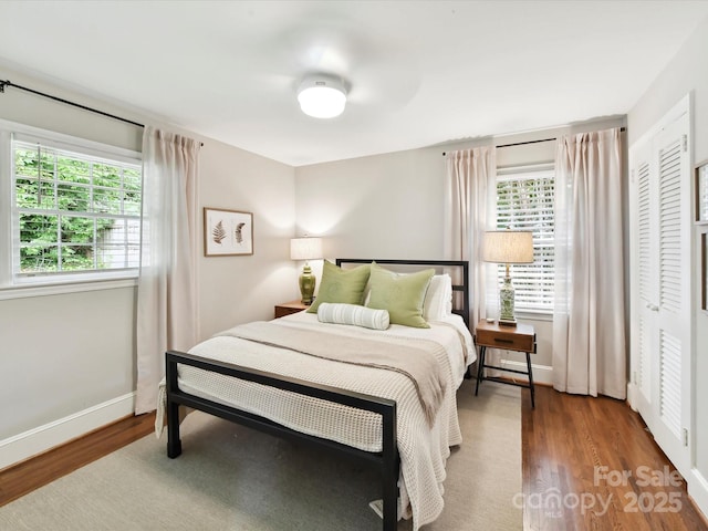 1638 Wensley Dr, Charlotte, NC 28210 - bedroom featuring wood finished floors, multiple windows, and baseboards