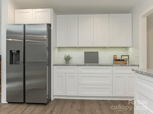 406 Wilcrest Dr, Matthews, NC 28105 - kitchen with stainless steel refrigerator with ice dispenser, white cabinets, light stone counters, and wood finished floors
