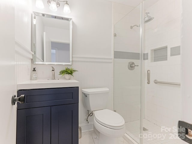 406 Wilcrest Dr, Matthews, NC 28105 - full bathroom featuring toilet, a stall shower, vanity, and wainscoting