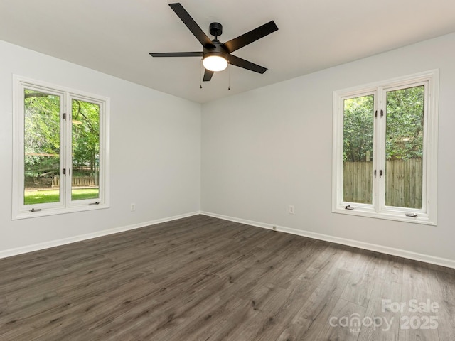406 Wilcrest Dr, Matthews, NC 28105 - empty room with healthy amount of natural light, baseboards, dark wood-style flooring, and a ceiling fan