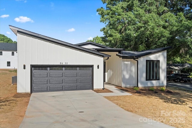 8632 Cedarbrook Dr, Charlotte, NC 28215 - mid-century modern home featuring an attached garage, driveway, and central AC unit