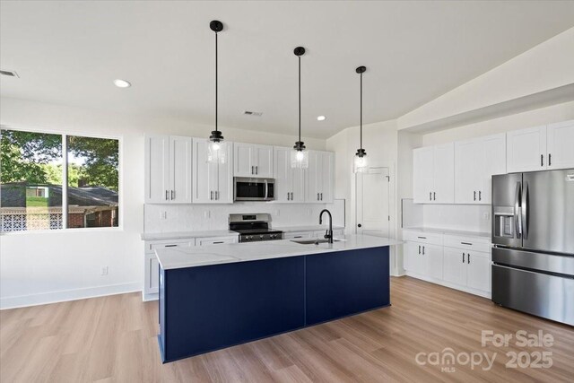 8632 Cedarbrook Dr, Charlotte, NC 28215 - kitchen featuring appliances with stainless steel finishes, a sink, light countertops, white cabinets, and decorative light fixtures