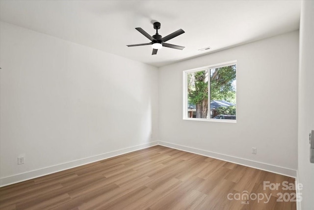 8632 Cedarbrook Dr, Charlotte, NC 28215 - spare room featuring wood finished floors, ceiling fan, and baseboards