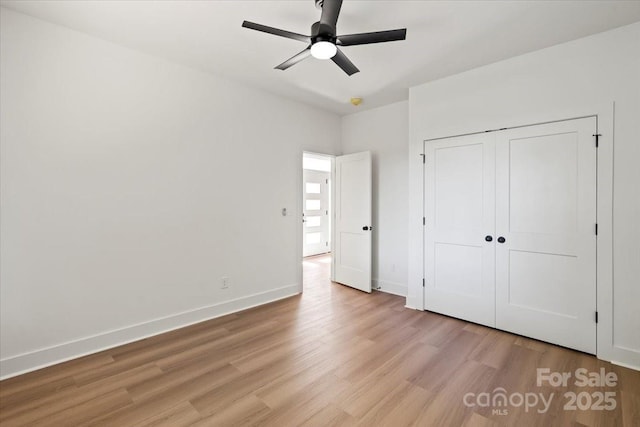 8632 Cedarbrook Dr, Charlotte, NC 28215 - unfurnished bedroom with light wood-type flooring, baseboards, a closet, and ceiling fan