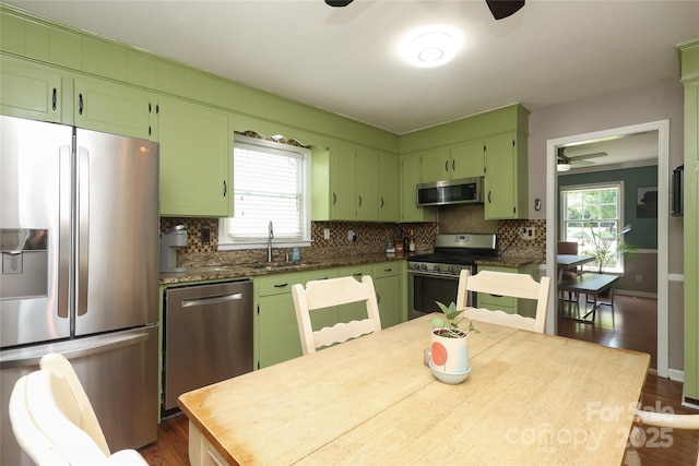2443 Knickerbocker Dr, Charlotte, NC 28212 - kitchen featuring stainless steel appliances, a ceiling fan, backsplash, and plenty of natural light