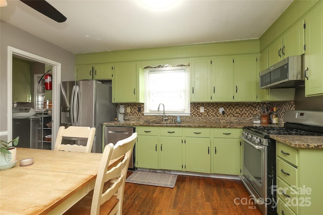 2443 Knickerbocker Dr, Charlotte, NC 28212 - kitchen with appliances with stainless steel finishes, dark wood-type flooring, backsplash, ceiling fan, and dark stone counters