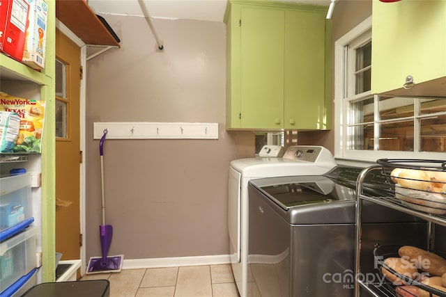 2443 Knickerbocker Dr, Charlotte, NC 28212 - laundry area featuring cabinet space, independent washer and dryer, and light tile patterned floors