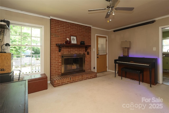 2443 Knickerbocker Dr, Charlotte, NC 28212 - carpeted living room featuring ornamental molding, ceiling fan, plenty of natural light, and a brick fireplace