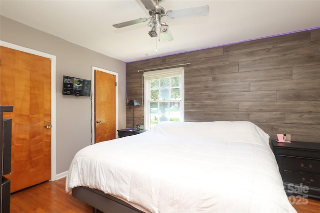 2443 Knickerbocker Dr, Charlotte, NC 28212 - bedroom with wood finished floors, ceiling fan, and wood walls