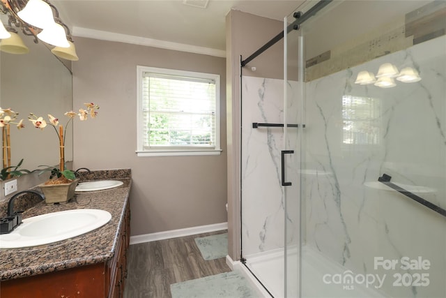 2443 Knickerbocker Dr, Charlotte, NC 28212 - full bathroom featuring double vanity, a marble finish shower, wood finished floors, and crown molding