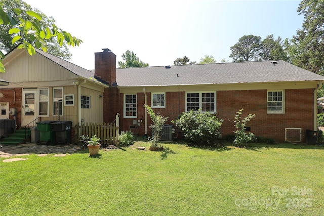 2443 Knickerbocker Dr, Charlotte, NC 28212 - rear view of house with a chimney, brick siding, and a lawn