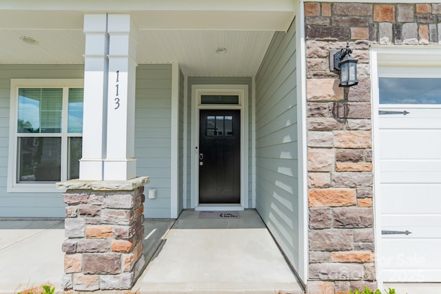 113 Summerhill Dr, Mooresville, NC 28115 - property entrance with stone siding and a porch