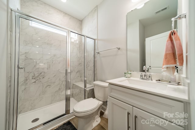113 Summerhill Dr, Mooresville, NC 28115 - bathroom with toilet, vanity, a stall shower, and wood finished floors