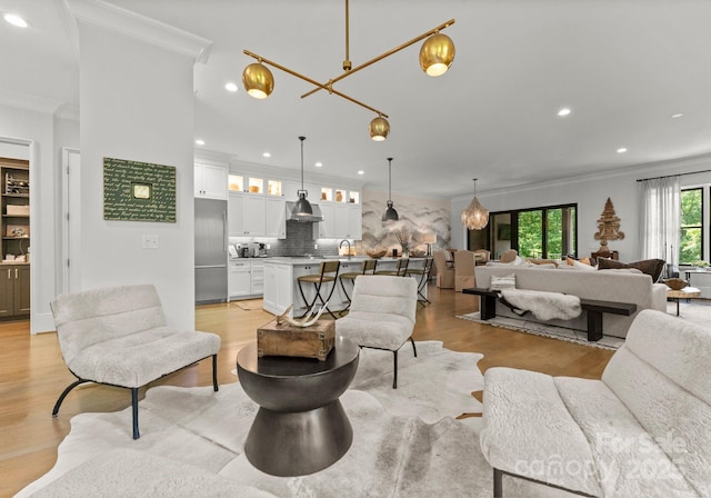 1160 S Kings Dr, Charlotte, NC 28207 - living area featuring crown molding, light wood-style floors, and recessed lighting