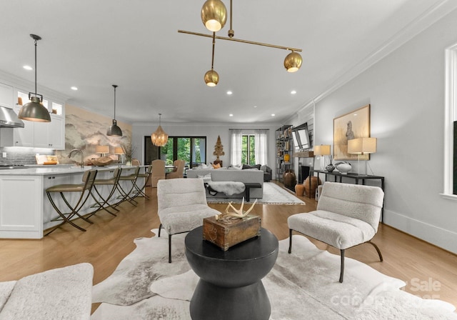 1160 S Kings Dr, Charlotte, NC 28207 - living room featuring ornamental molding, light wood finished floors, and recessed lighting