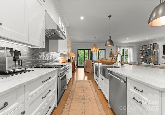 1160 S Kings Dr, Charlotte, NC 28207 - kitchen with stainless steel appliances, extractor fan, a sink, white cabinetry, and healthy amount of natural light