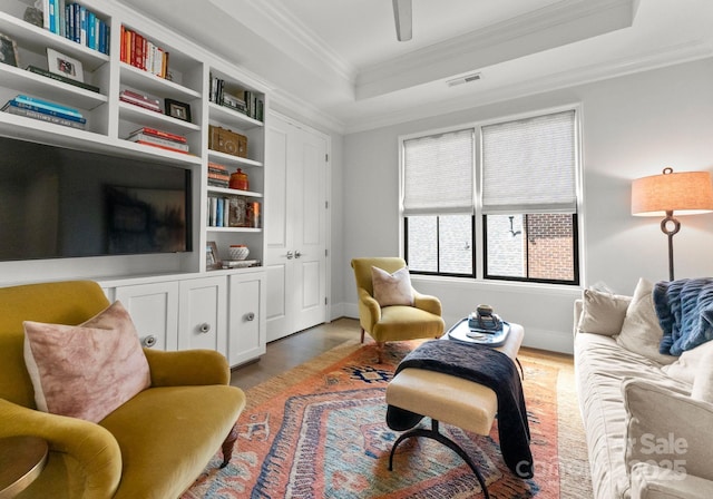 1160 S Kings Dr, Charlotte, NC 28207 - living area featuring a tray ceiling, crown molding, wood finished floors, and baseboards