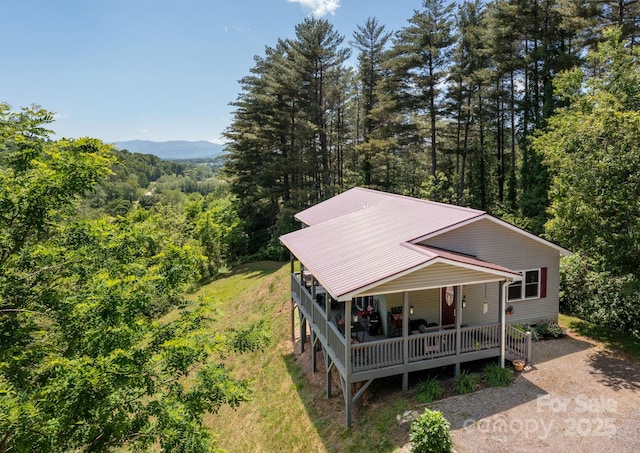 174 Diamond Pt, Canton, NC 28716 - view of front of property with a porch, a wooded view, and metal roof