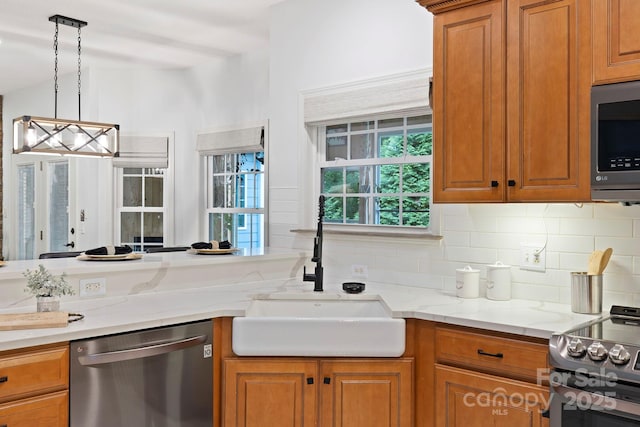 21 Hope Rd, Weaverville, NC 28787 - kitchen with stainless steel appliances, a sink, backsplash, and brown cabinets
