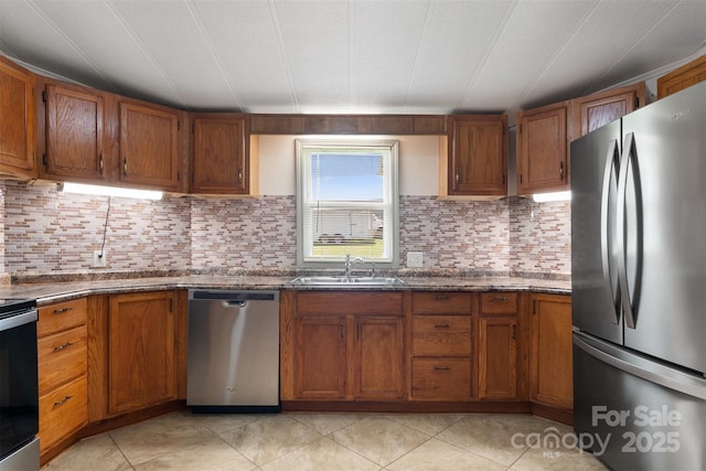 4648 Rifle Range Rd, Conover, NC 28613 - kitchen with appliances with stainless steel finishes, a sink, and brown cabinets