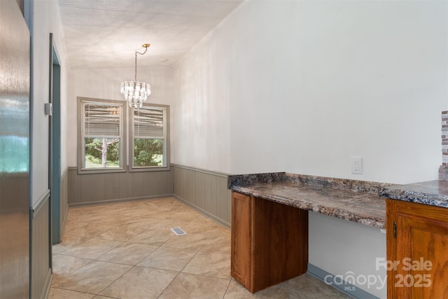 4648 Rifle Range Rd, Conover, NC 28613 - unfurnished dining area featuring a chandelier and a wainscoted wall