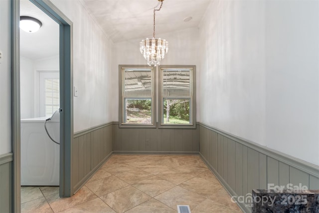 4648 Rifle Range Rd, Conover, NC 28613 - unfurnished dining area featuring washer / clothes dryer, wainscoting, crown molding, and a chandelier