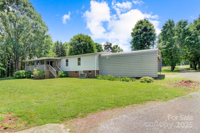 4648 Rifle Range Rd, Conover, NC 28613 - view of front of house with central air condition unit, a front yard, covered porch, and crawl space