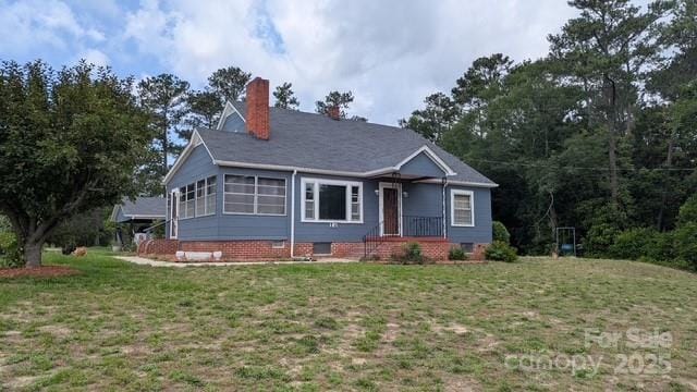 187 Cartledge Creek Rd, Rockingham, NC 28379 - ranch-style home with a front yard and a chimney