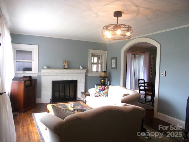 187 Cartledge Creek Rd, Rockingham, NC 28379 - living area with arched walkways, a brick fireplace, crown molding, and wood finished floors