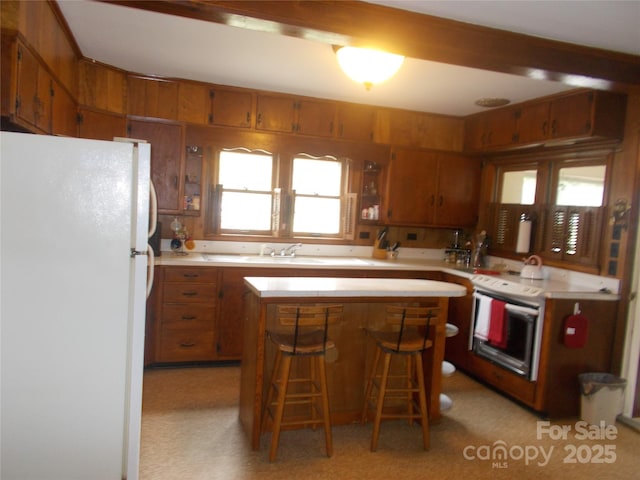 187 Cartledge Creek Rd, Rockingham, NC 28379 - kitchen featuring freestanding refrigerator, brown cabinets, and light countertops