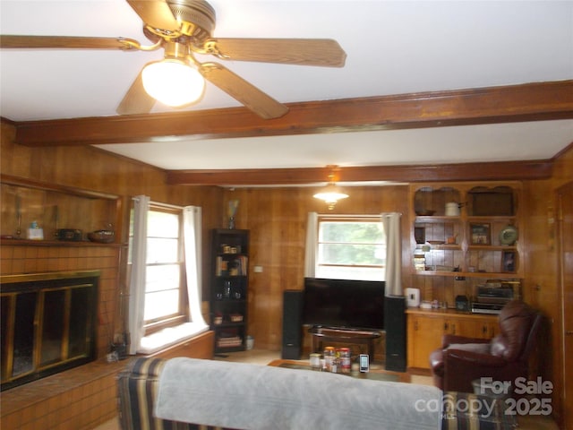 187 Cartledge Creek Rd, Rockingham, NC 28379 - living area featuring beamed ceiling, a ceiling fan, wood walls, and a fireplace