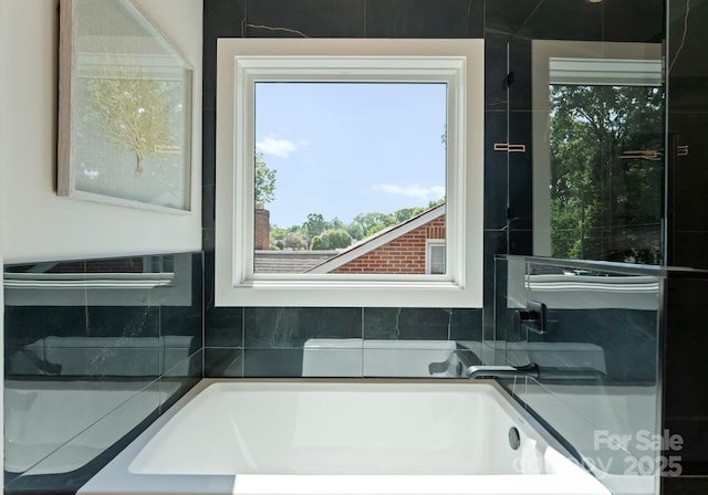 2004 St John St, Charlotte, NC 28216 - full bathroom featuring a garden tub, tasteful backsplash, and plenty of natural light