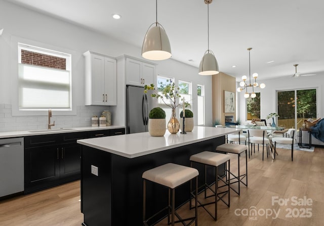 2004 St John St, Charlotte, NC 28216 - kitchen featuring stainless steel appliances, light countertops, open floor plan, a kitchen island, and recessed lighting