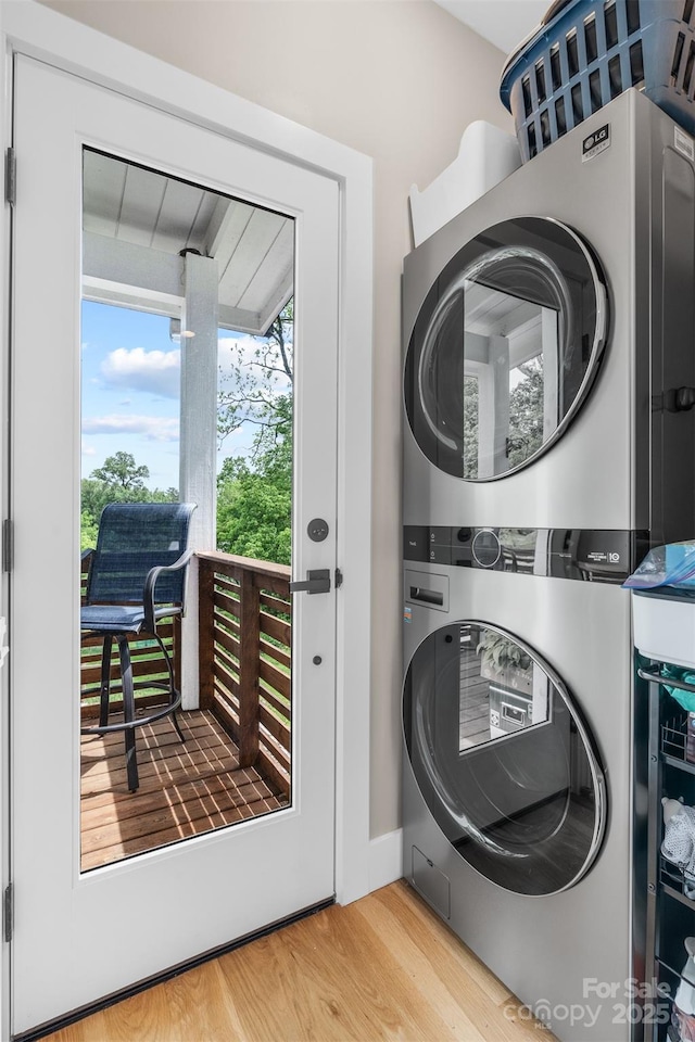 109 Thurland Ave, Asheville, NC 28803 - washroom featuring stacked washer and clothes dryer and wood finished floors