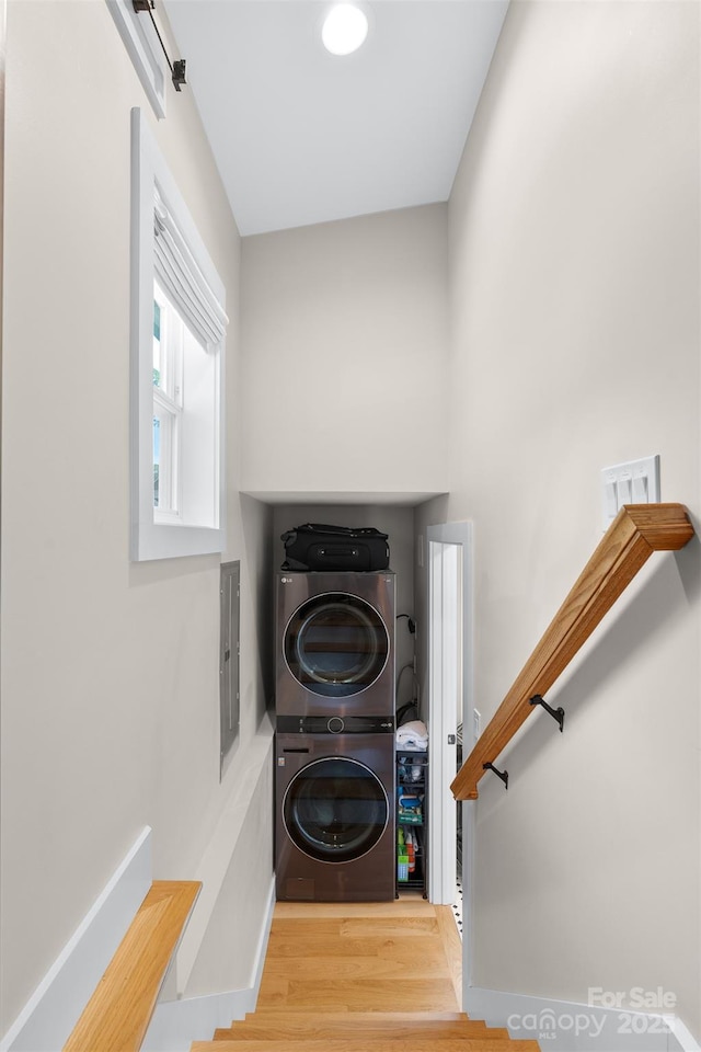109 Thurland Ave, Asheville, NC 28803 - washroom featuring stacked washing machine and dryer, wood finished floors, and electric panel