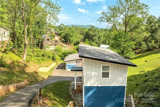 109 Thurland Ave, Asheville, NC 28803 - view of property exterior with board and batten siding, a shingled roof, and asphalt driveway