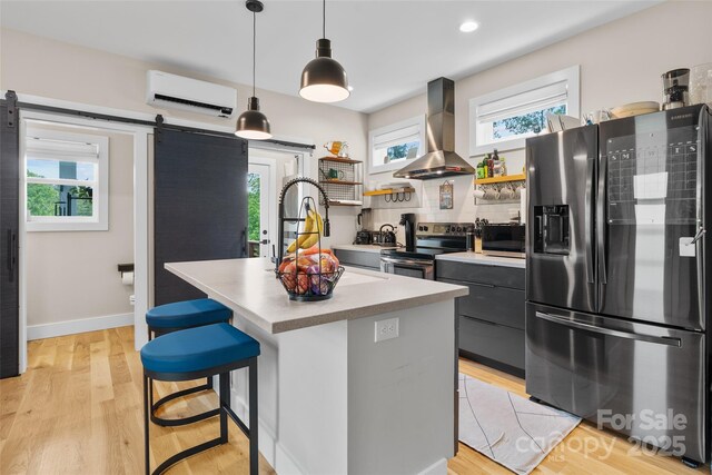 109 Thurland Ave, Asheville, NC 28803 - kitchen featuring appliances with stainless steel finishes, island exhaust hood, an AC wall unit, open shelves, and healthy amount of natural light