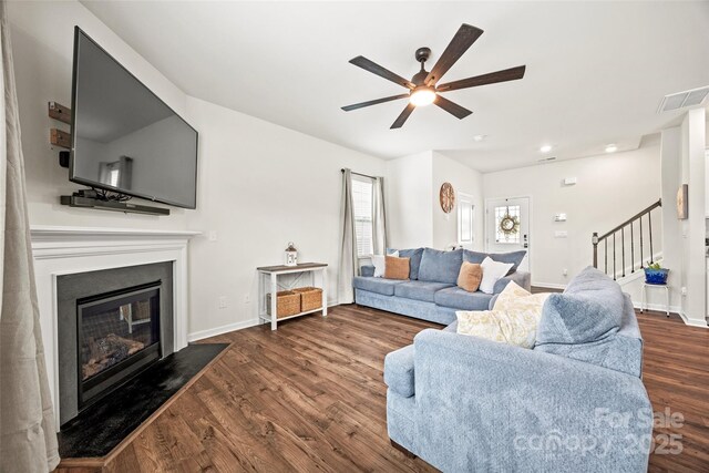 449 Misty Law Ln, Clover, SC 29710 - living area with stairs, a ceiling fan, dark wood finished floors, a glass covered fireplace, and baseboards