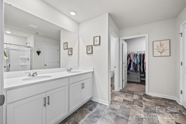 449 Misty Law Ln, Clover, SC 29710 - full bathroom with baseboards, double vanity, toilet, a stall shower, and stone finish floors