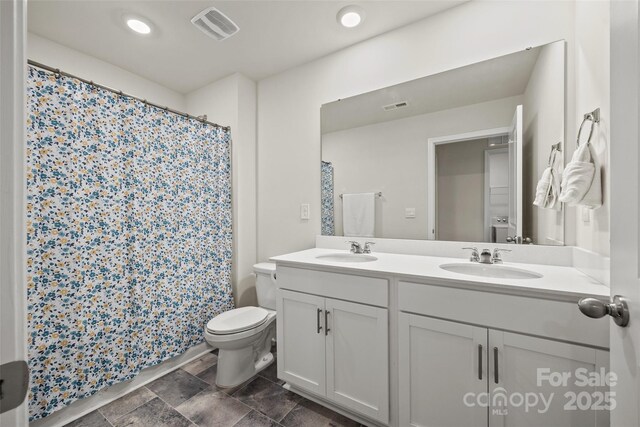 449 Misty Law Ln, Clover, SC 29710 - bathroom featuring toilet, double vanity, a shower with curtain, stone finish flooring, and recessed lighting