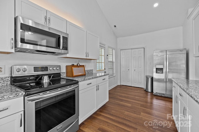 3801 Rosedown Dr, Matthews, NC 28105 - kitchen with appliances with stainless steel finishes, vaulted ceiling, white cabinetry, dark wood-style floors, and light stone countertops