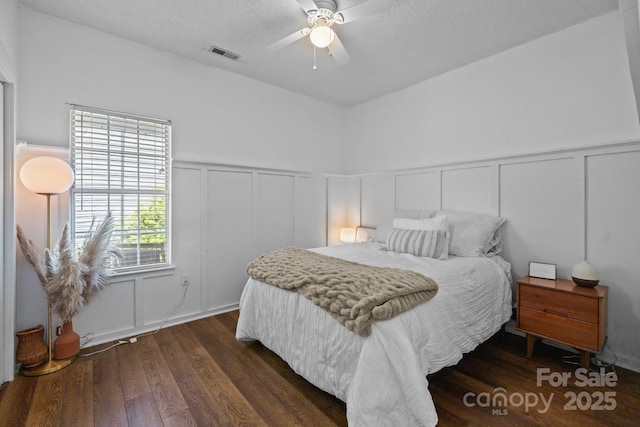 3801 Rosedown Dr, Matthews, NC 28105 - bedroom with a decorative wall, dark wood-style floors, a wainscoted wall, and ceiling fan